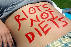 Stomach with Riots Not Diets painted on it courtesy of Flickr user Gaelx
